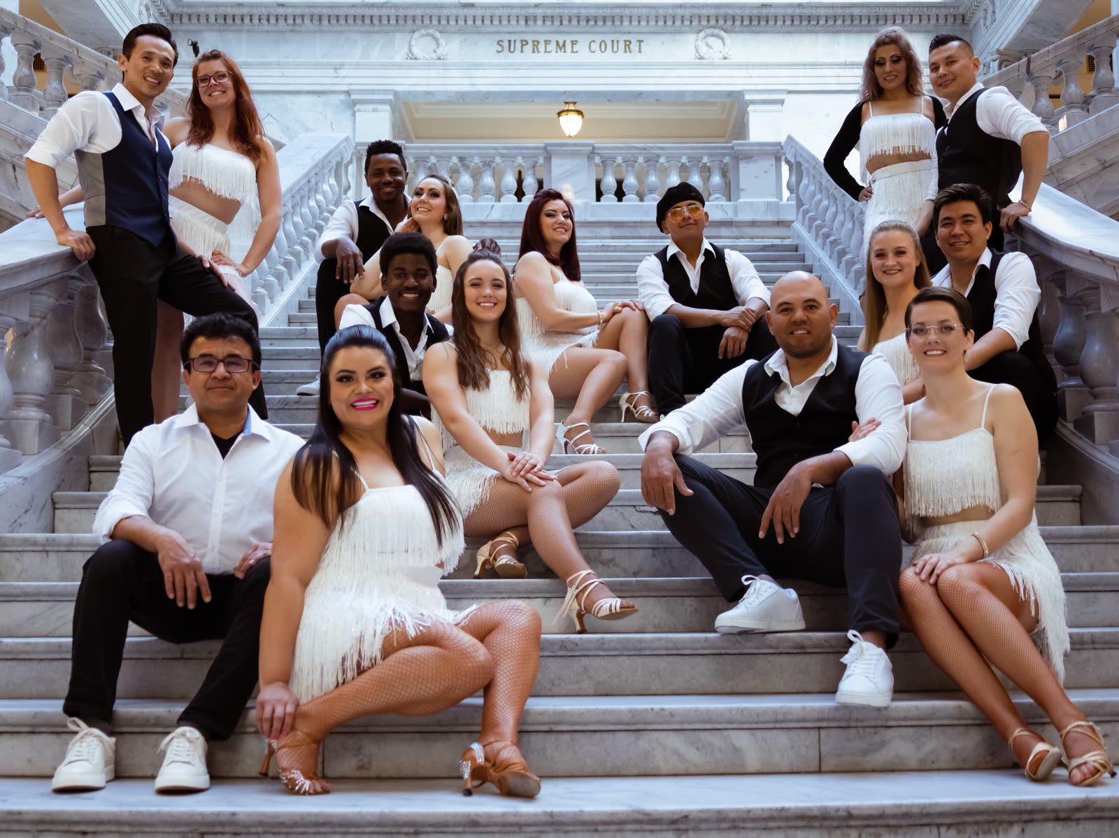 The Dance 4 a Cause team posing on marble steps