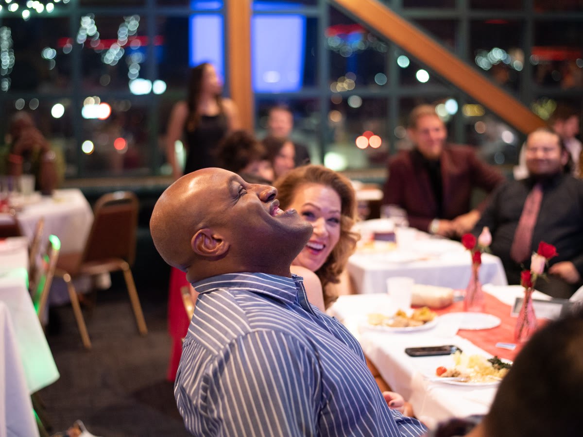 A guest laughing at his table