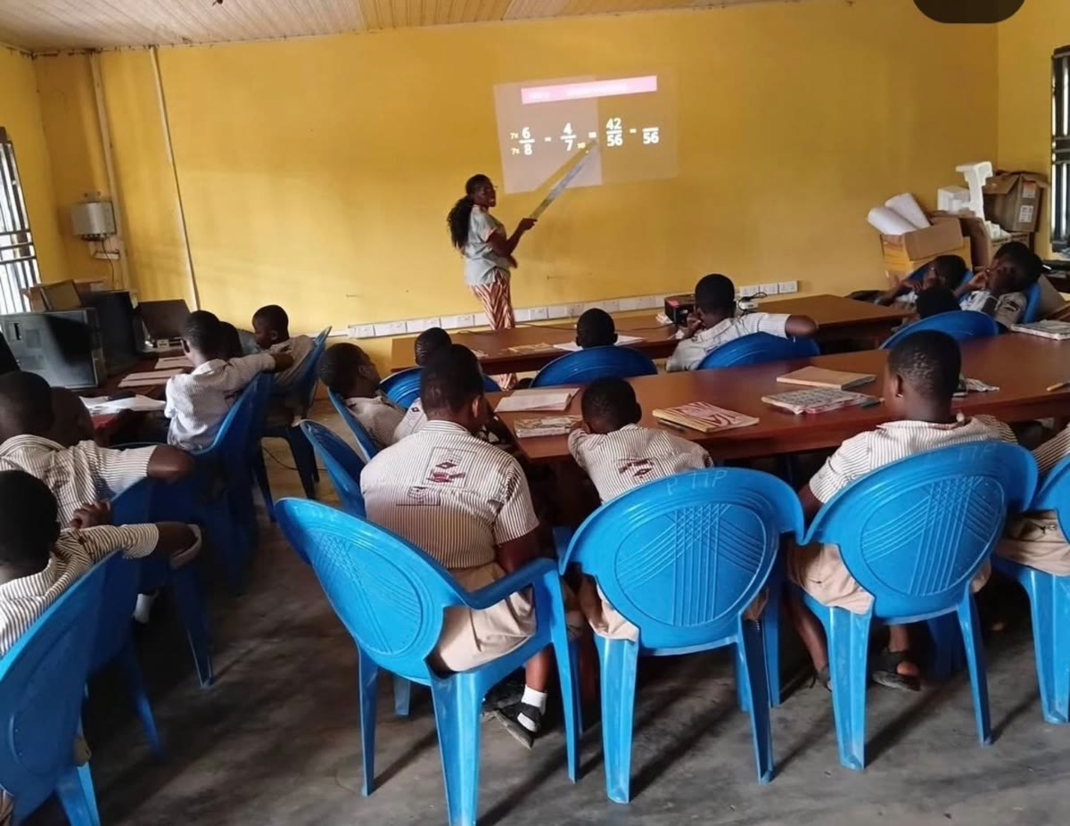 A teacher leads a math lesson on the projector in the new ICT lab at Dadome DA Basic School