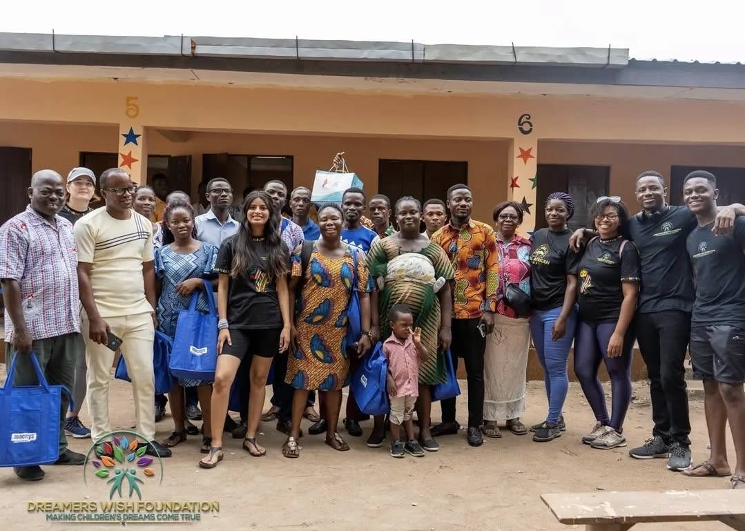 Mama Josephine with teachers, volunteers and community members in front of Dadome DA Basic School in Ghana's Volta Region