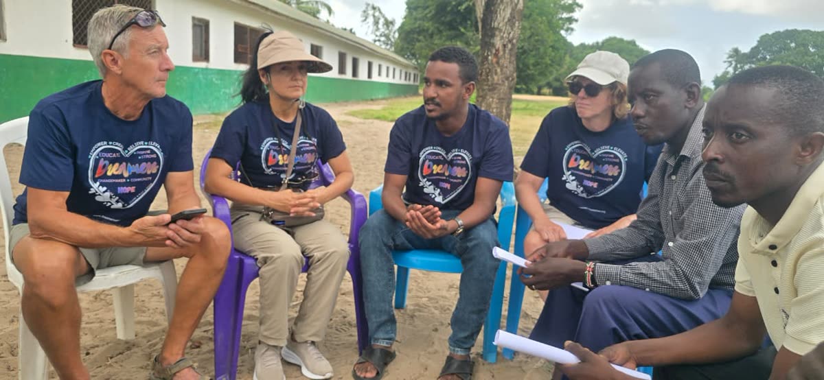 Volunteers meeting with local partners at a school in Kenya